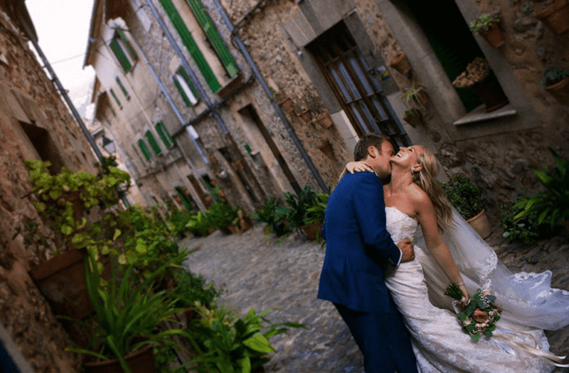 Professional wedding videographer filming an emotional wedding moment