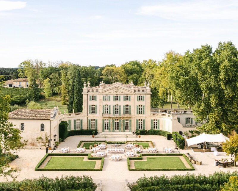 Aerial drone view of Château de Tourreau wedding venue with outdoor ceremony setup in Provence France