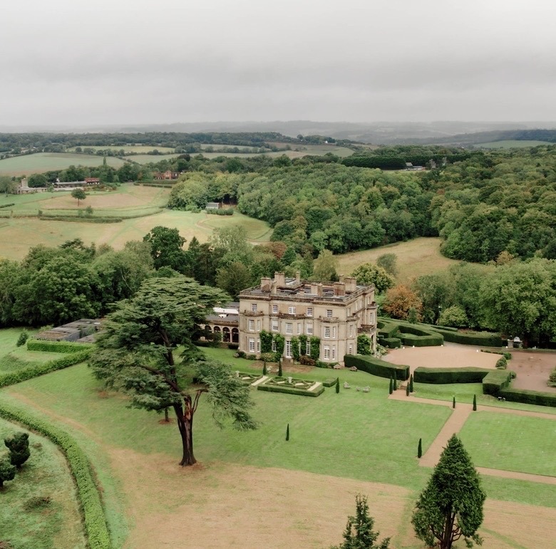 Aerial view of Hedsor House wedding venue surrounded by manicured gardens and Buckinghamshire countryside